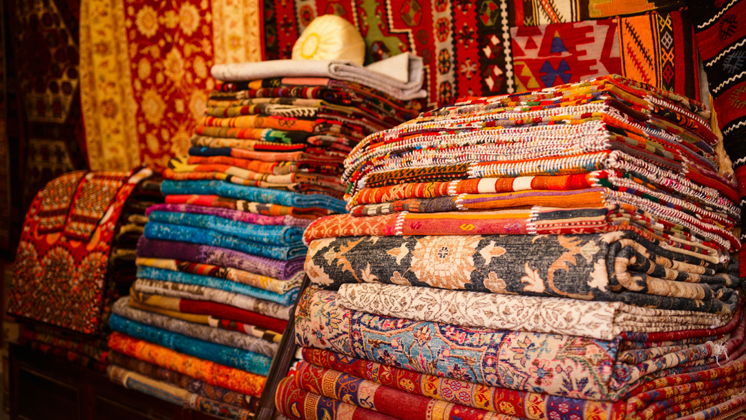 Artisans at work in a Turkish carpet factory, weaving vibrant Anatolian kilims and luxurious Ottoman silk carpets