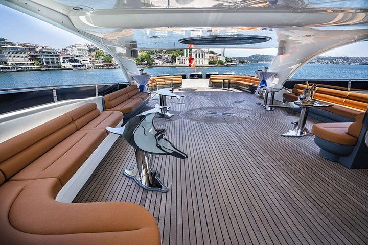 Guests capturing the essence of Istanbul's beauty from the deck of a private yacht cruising along the Bosphorus.